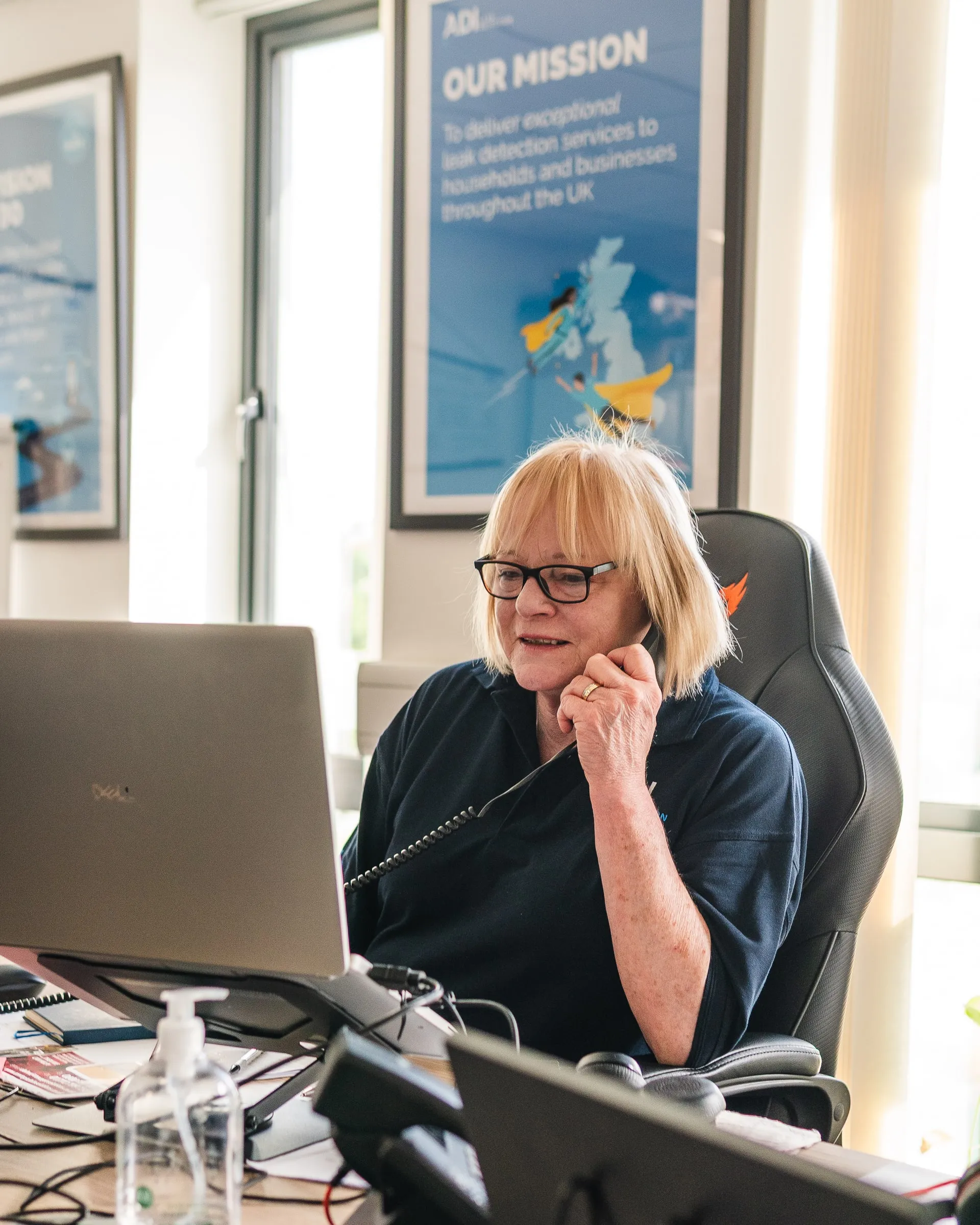 Member of ADI's office team on the phone at her desk
