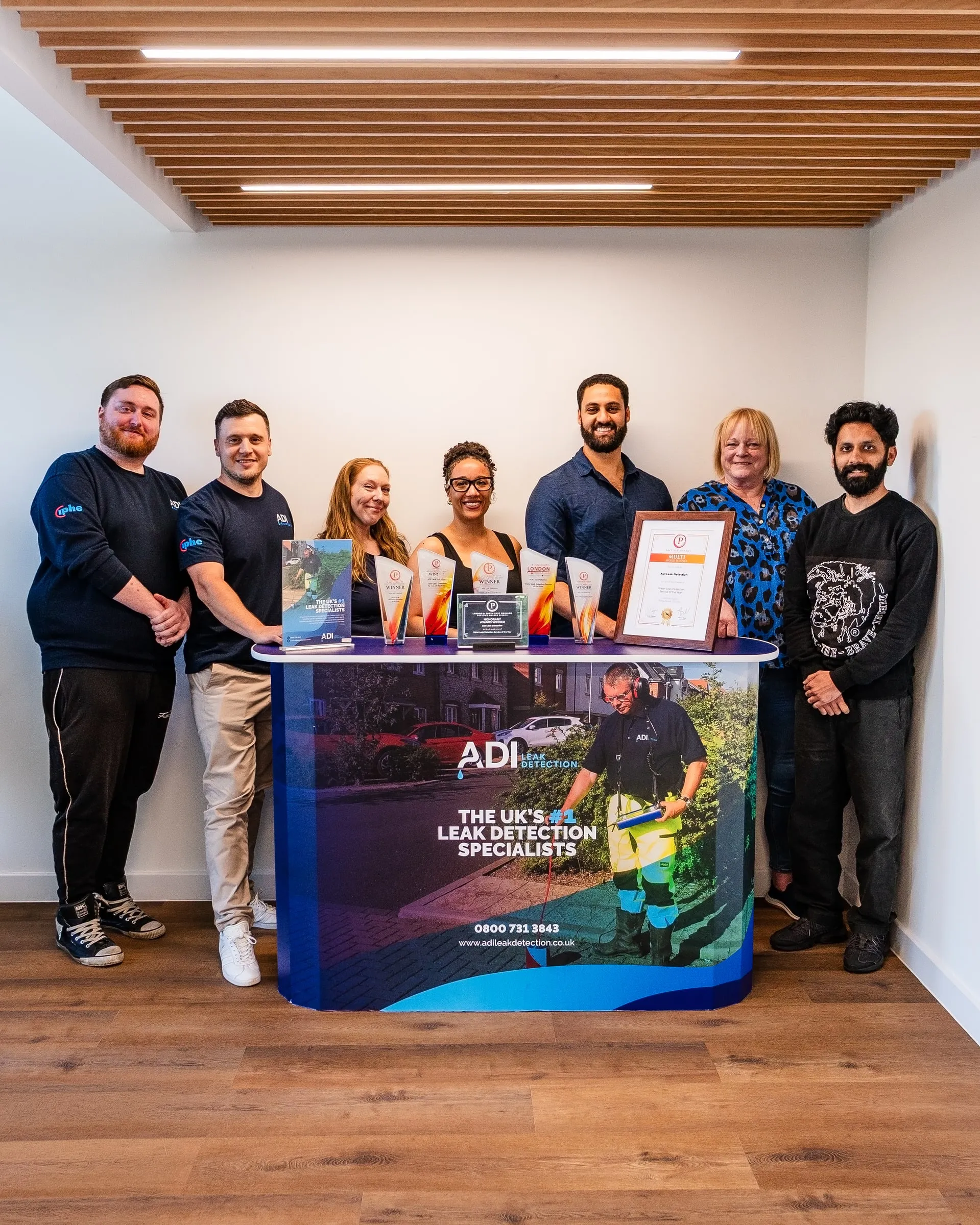 The ADI Leak Detection office team standing at the company's exhibition stand